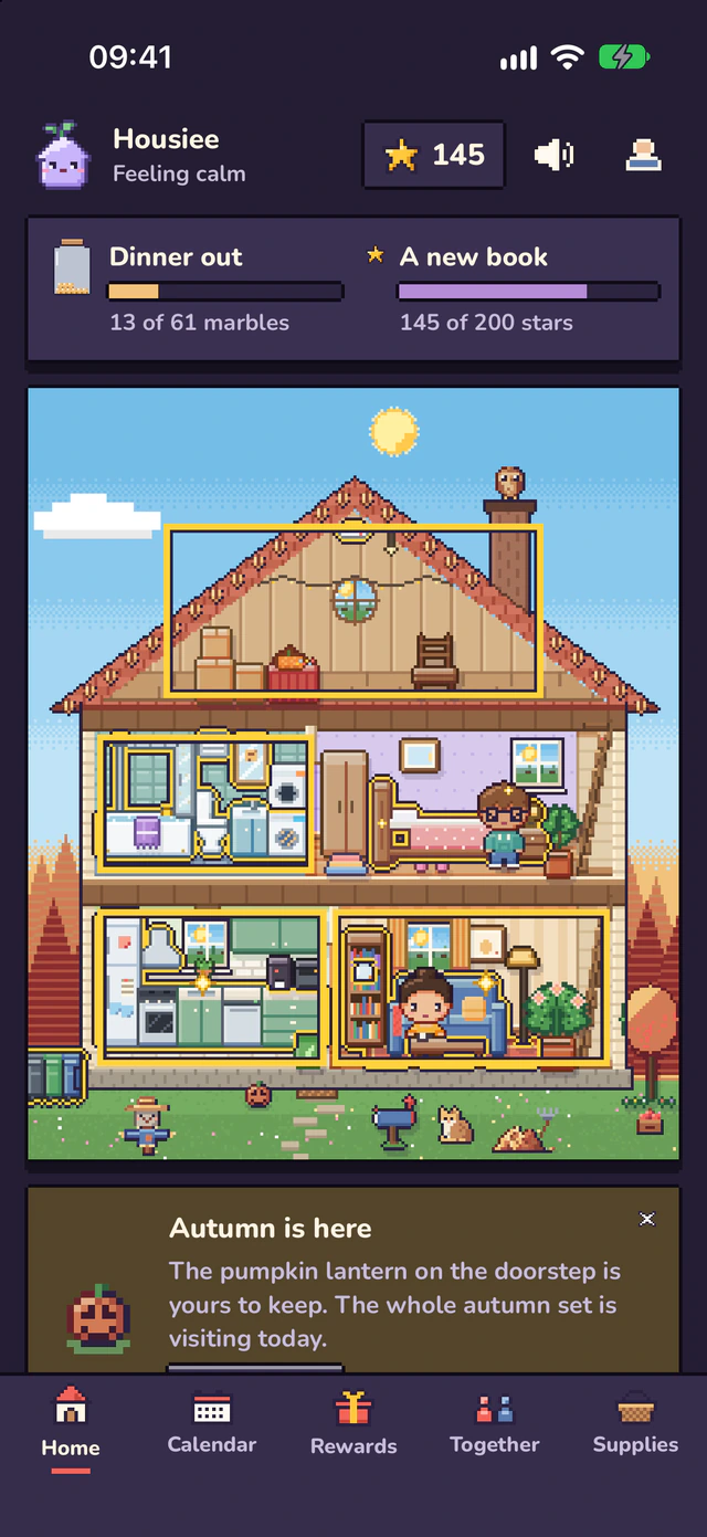 The Home screen in dark mode: the dollhouse under a blue sky, with a cat visiting the garden.